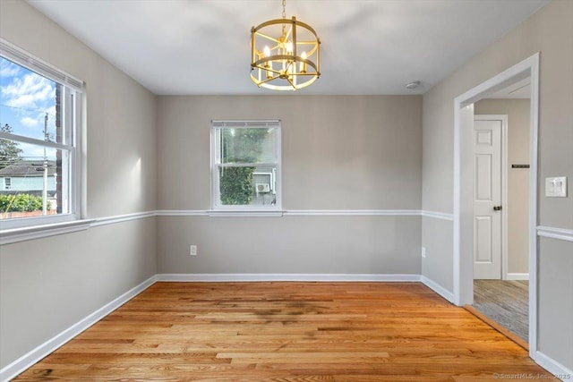 210 Highland Ave, West Haven, CT 06516 - unfurnished room featuring a chandelier, light wood finished floors, and healthy amount of natural light