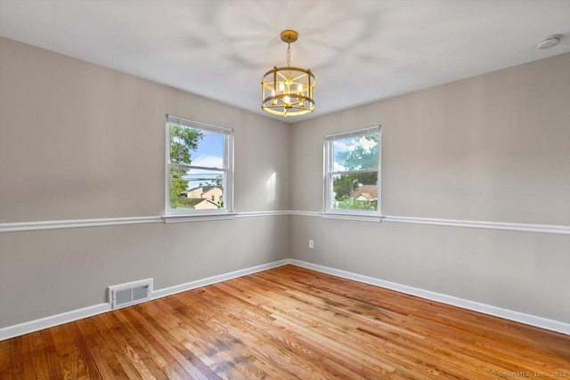 210 Highland Ave, West Haven, CT 06516 - unfurnished room with a chandelier, healthy amount of natural light, light wood-type flooring, and a smoke detector