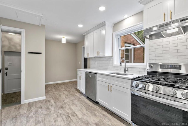 210 Highland Ave, West Haven, CT 06516 - kitchen with appliances with stainless steel finishes, under cabinet range hood, backsplash, white cabinetry, and light countertops
