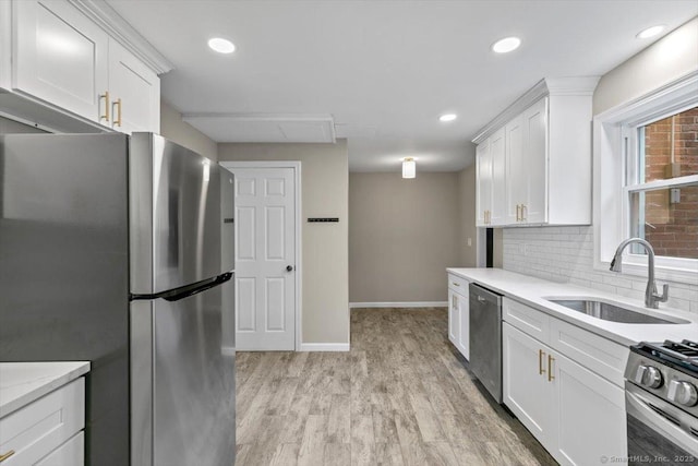 210 Highland Ave, West Haven, CT 06516 - kitchen featuring stainless steel appliances, white cabinetry, light wood-type flooring, backsplash, and recessed lighting