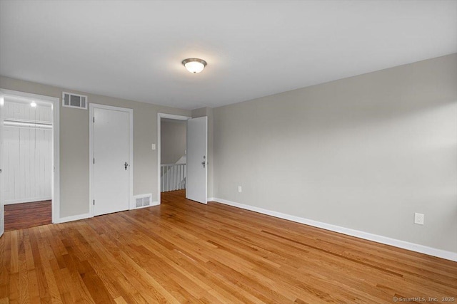210 Highland Ave, West Haven, CT 06516 - unfurnished bedroom featuring wood finished floors and a spacious closet