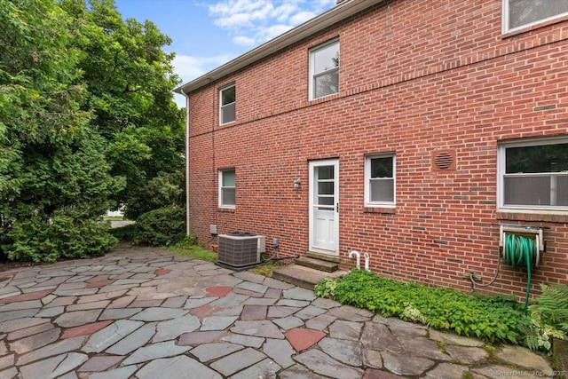 210 Highland Ave, West Haven, CT 06516 - back of property with brick siding, a patio, and entry steps