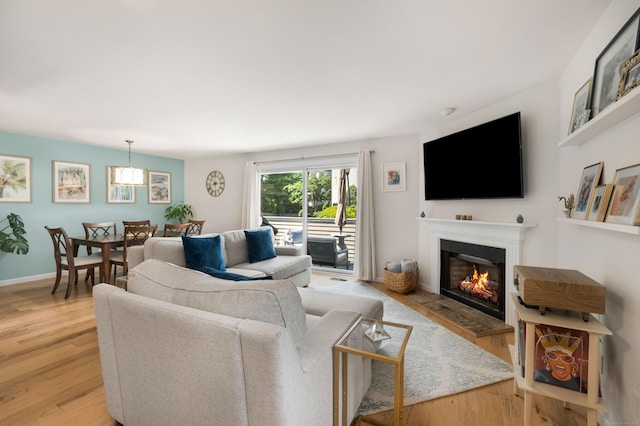 76 Cedarcrest Ct Unit 76, Shelton, CT 06484 - living room featuring a glass covered fireplace and light wood-style floors