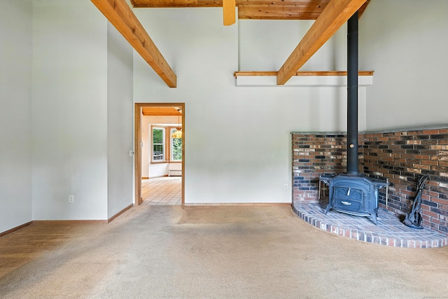 30 Park Rd, Oxford, CT 06478 - unfurnished living room with a wood stove, carpet floors, beam ceiling, and high vaulted ceiling