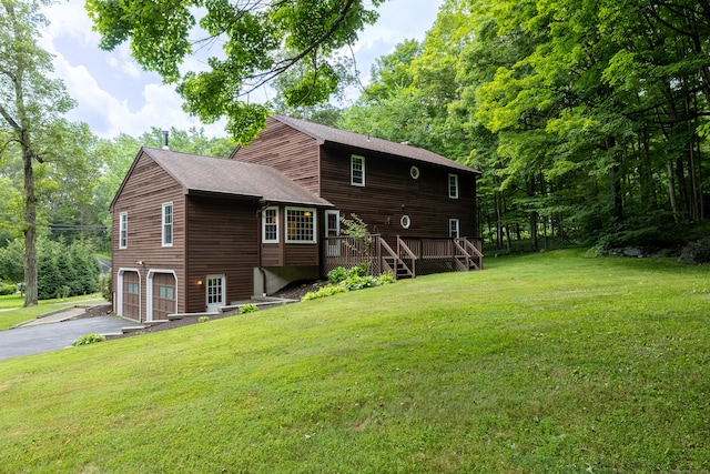 30 Park Rd, Oxford, CT 06478 - back of house featuring asphalt driveway, an attached garage, a yard, a shingled roof, and stairs