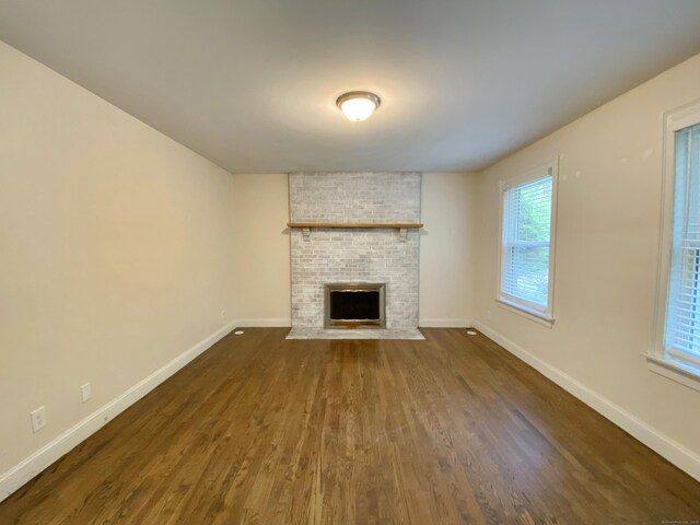 260 Stearns Rd, Mansfield, CT 06268 - unfurnished living room with dark wood-style flooring and a fireplace