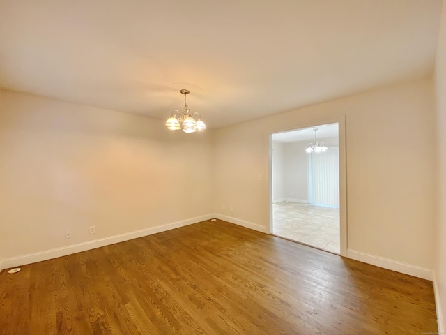 260 Stearns Rd, Mansfield, CT 06268 - empty room with a chandelier and wood finished floors