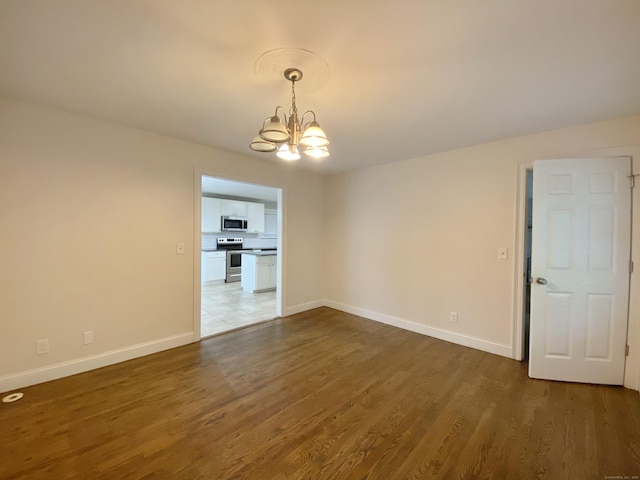 260 Stearns Rd, Mansfield, CT 06268 - empty room featuring a chandelier and wood finished floors