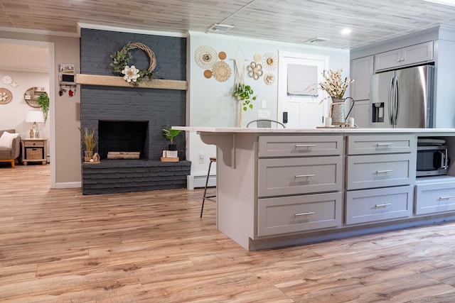 3 Olde Salem Dr, Somers, CT 06071 - kitchen with appliances with stainless steel finishes, gray cabinets, crown molding, a baseboard radiator, and light wood-style flooring