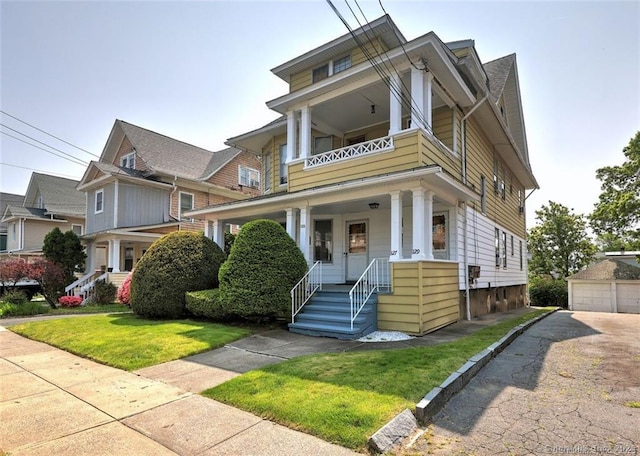 125 Marion St, Bridgeport, CT 06606 - traditional style home featuring covered porch, a front lawn, a garage, and a balcony