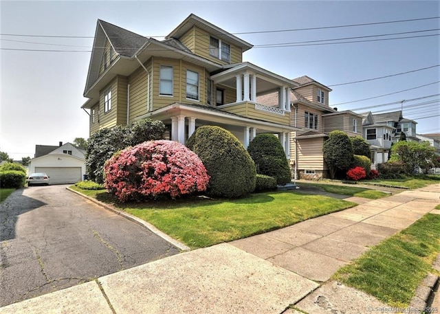 125 Marion St, Bridgeport, CT 06606 - view of front of house featuring a detached garage and a front lawn