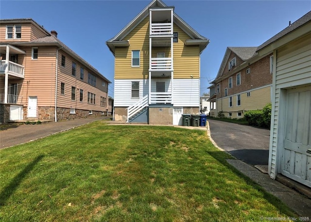 125 Marion St, Bridgeport, CT 06606 - rear view of house with a lawn
