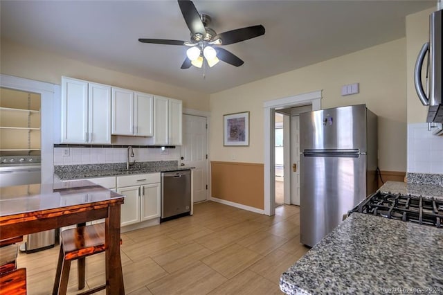 125 Marion St, Bridgeport, CT 06606 - kitchen with stainless steel appliances, white cabinets, a ceiling fan, tasteful backsplash, and stone countertops