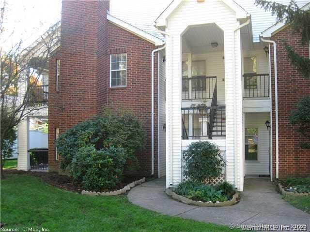 31 High St Apt 11206, East Hartford, CT 06118 - property entrance featuring brick siding and a chimney