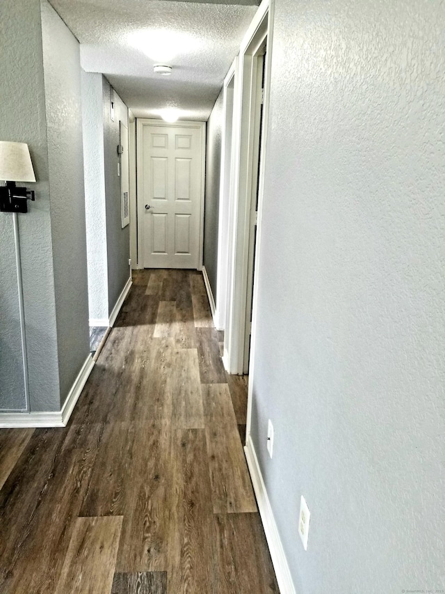 31 High St Apt 11206, East Hartford, CT 06118 - corridor featuring a textured wall, dark wood finished floors, and a textured ceiling
