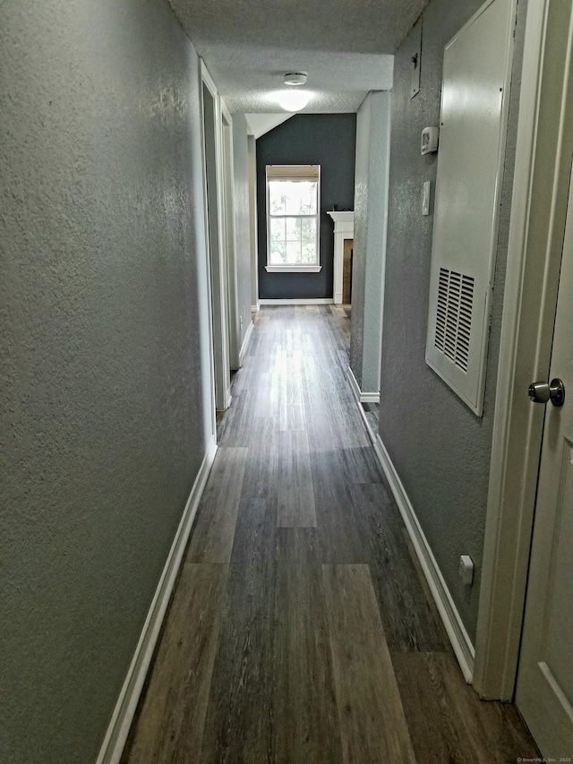 31 High St Apt 11206, East Hartford, CT 06118 - corridor featuring a textured wall, dark wood-style flooring, and vaulted ceiling