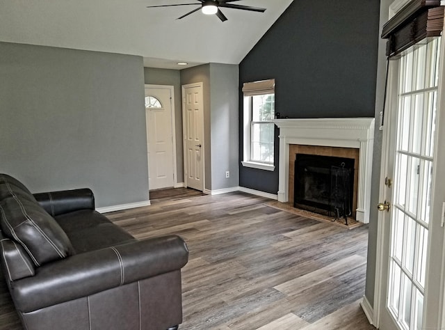 31 High St Apt 11206, East Hartford, CT 06118 - living room featuring ceiling fan, vaulted ceiling, a tiled fireplace, and wood finished floors