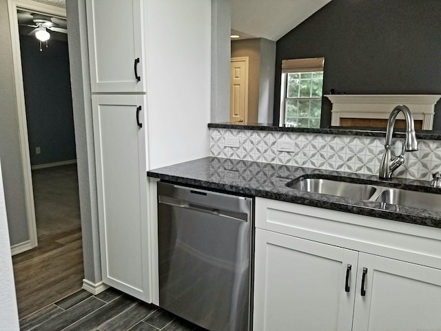 31 High St Apt 11206, East Hartford, CT 06118 - kitchen featuring stainless steel dishwasher, backsplash, dark wood-type flooring, white cabinets, and lofted ceiling