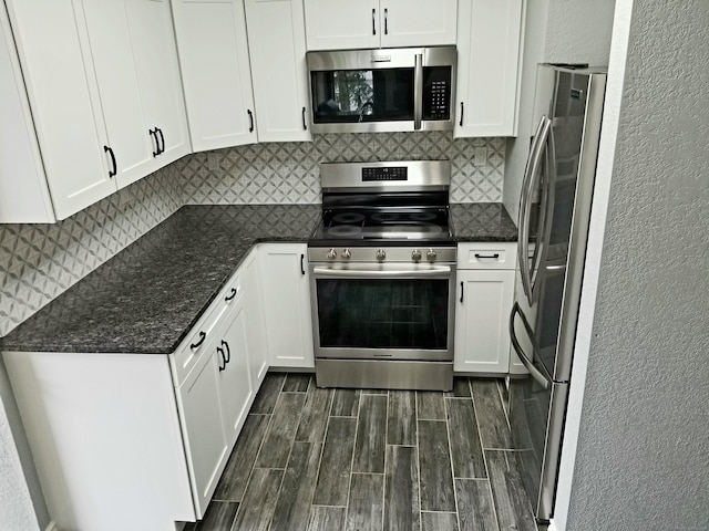 31 High St Apt 11206, East Hartford, CT 06118 - kitchen with stainless steel appliances, wood finish floors, decorative backsplash, white cabinets, and dark stone countertops