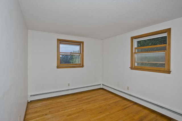 9 Mountain Rd, Granby, CT 06060 - spare room with a baseboard heating unit, plenty of natural light, and light wood-type flooring