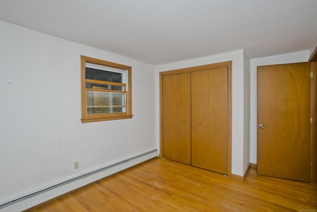 9 Mountain Rd, Granby, CT 06060 - unfurnished bedroom featuring a baseboard radiator, light wood-type flooring, and a closet
