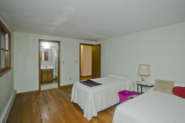 9 Mountain Rd, Granby, CT 06060 - bedroom featuring baseboard heating, wood finished floors, and ensuite bath