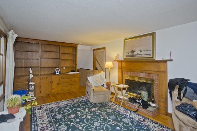 9 Mountain Rd, Granby, CT 06060 - living area with wood finished floors and a brick fireplace