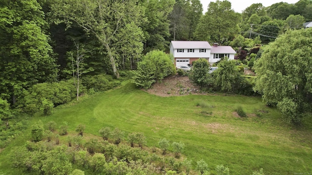 9 Mountain Rd, Granby, CT 06060 - view of grassy yard with a forest view, an attached garage, and driveway