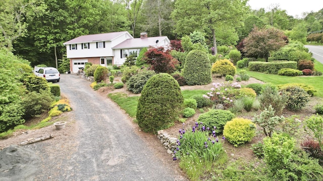 9 Mountain Rd, Granby, CT 06060 - view of front of house with a garage, driveway, and a chimney