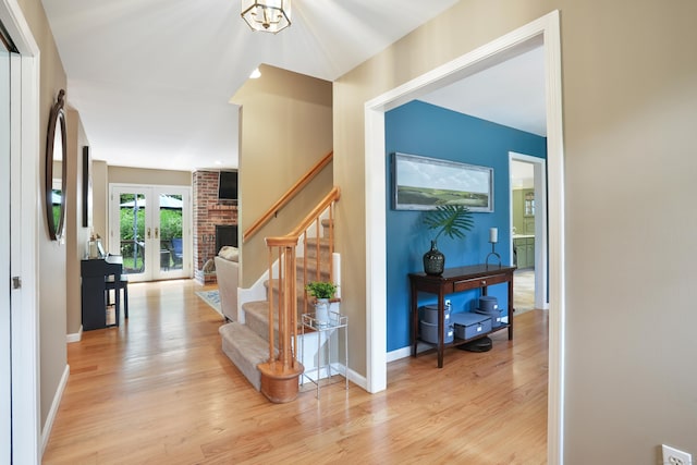 731 N Park Ave, Redding, CT 06896 - foyer entrance featuring french doors, light wood finished floors, and stairway