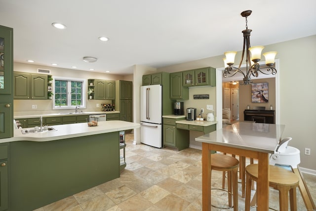 731 N Park Ave, Redding, CT 06896 - kitchen with green cabinets, freestanding refrigerator, light countertops, a kitchen bar, and stainless steel dishwasher
