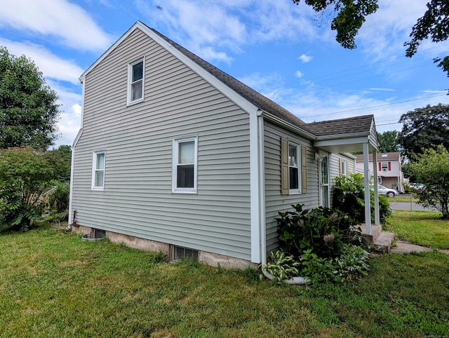 79 Dallas Ave, Plainville, CT 06062 - view of side of property with a lawn and roof with shingles