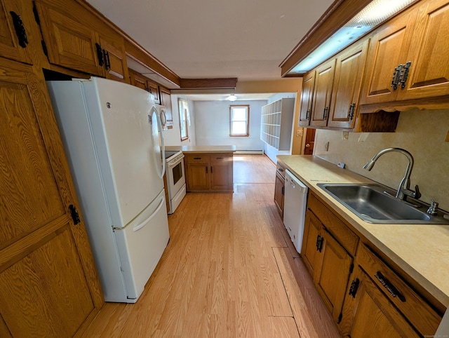 79 Dallas Ave, Plainville, CT 06062 - kitchen with white appliances, brown cabinets, light wood-type flooring, a peninsula, and light countertops