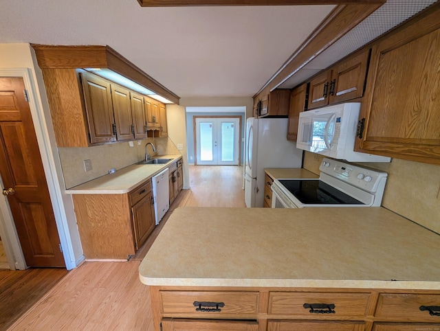 79 Dallas Ave, Plainville, CT 06062 - kitchen with white appliances, light wood finished floors, light countertops, and brown cabinetry