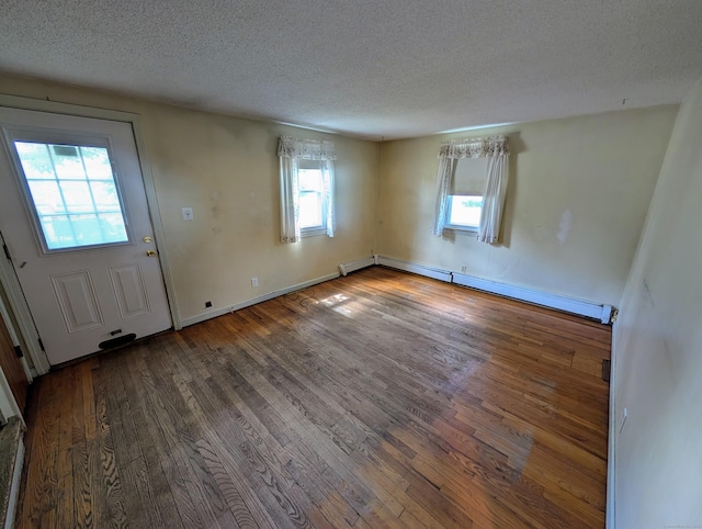 79 Dallas Ave, Plainville, CT 06062 - entryway with a baseboard radiator, wood finished floors, and a textured ceiling