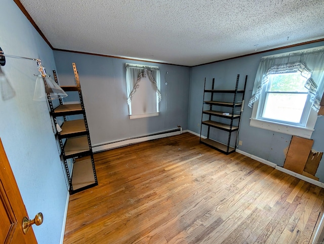 79 Dallas Ave, Plainville, CT 06062 - unfurnished bedroom featuring baseboard heating, wood finished floors, a textured ceiling, and ornamental molding