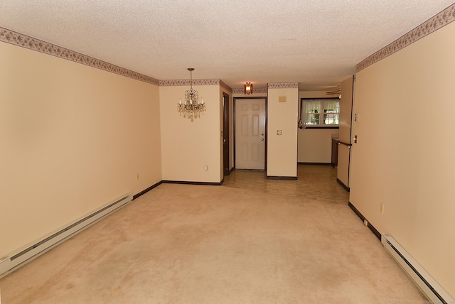 415 Lady Bug Ln Unit 415, Vernon, CT 06066 - spare room with baseboard heating, a baseboard radiator, a chandelier, a textured ceiling, and light carpet