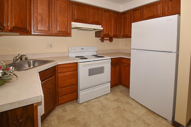 415 Lady Bug Ln Unit 415, Vernon, CT 06066 - kitchen with white appliances, under cabinet range hood, light countertops, brown cabinets, and light flooring