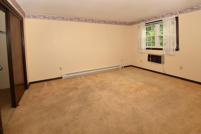 415 Lady Bug Ln Unit 415, Vernon, CT 06066 - unfurnished bedroom featuring a baseboard radiator, a wall mounted AC, light carpet, and a closet