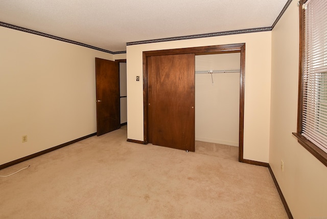 415 Lady Bug Ln Unit 415, Vernon, CT 06066 - unfurnished bedroom featuring light carpet, ornamental molding, and a closet