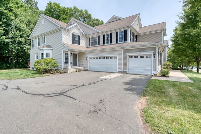 188 Sterling Dr Unit 188, Newington, CT 06111 - view of front of property featuring driveway, an attached garage, and a front lawn