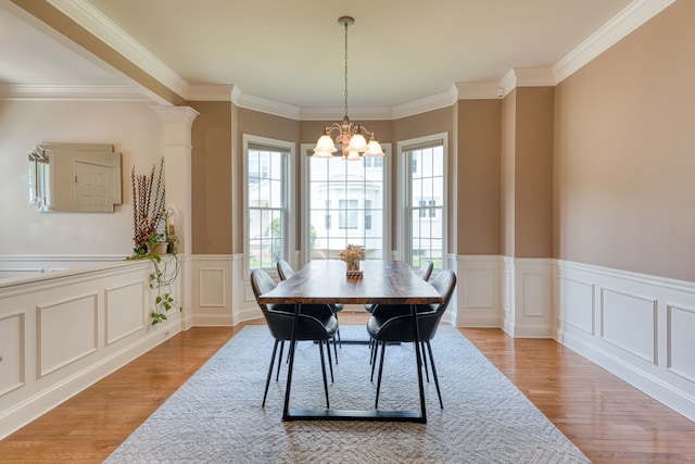 188 Sterling Dr Unit 188, Newington, CT 06111 - dining room with a chandelier, light wood-style floors, crown molding, a wainscoted wall, and a decorative wall