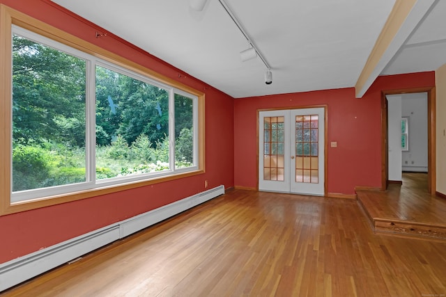 27 Tuttle Ct, Bethany, CT 06524 - unfurnished room with baseboard heating, hardwood / wood-style floors, plenty of natural light, and rail lighting