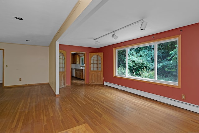 27 Tuttle Ct, Bethany, CT 06524 - spare room featuring baseboard heating, wood finished floors, and rail lighting