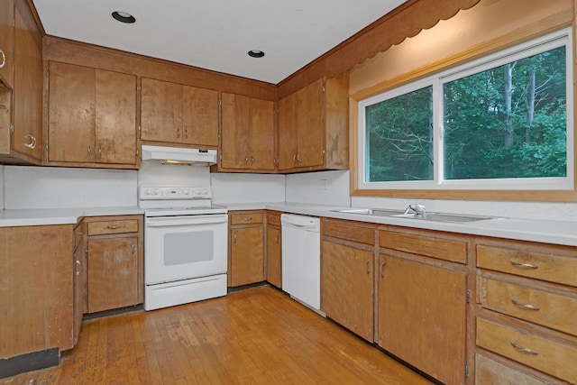 27 Tuttle Ct, Bethany, CT 06524 - kitchen featuring white appliances, under cabinet range hood, healthy amount of natural light, and brown cabinetry