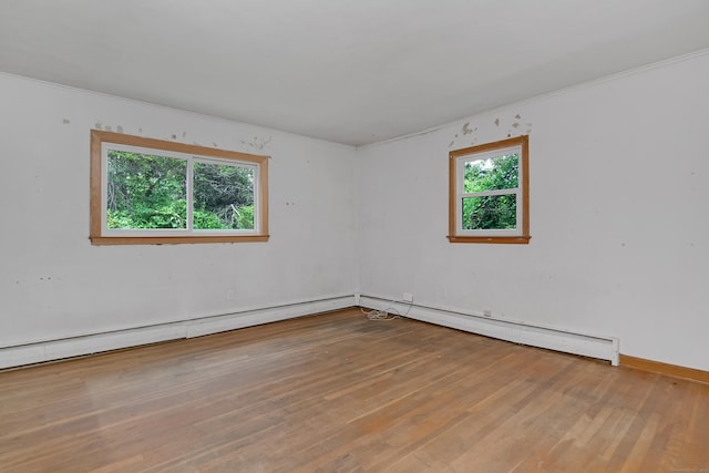27 Tuttle Ct, Bethany, CT 06524 - spare room featuring plenty of natural light, wood finished floors, crown molding, and a baseboard heating unit
