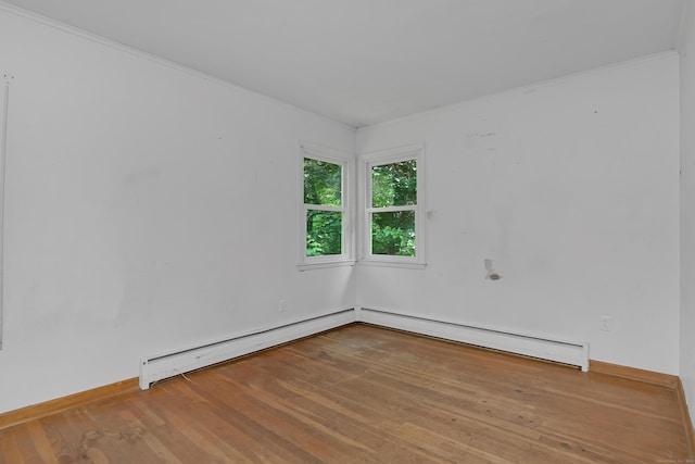 27 Tuttle Ct, Bethany, CT 06524 - empty room featuring wood finished floors, baseboard heating, a baseboard radiator, and ornamental molding