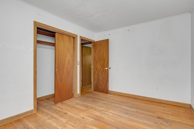 27 Tuttle Ct, Bethany, CT 06524 - unfurnished bedroom with light wood-style floors, ornamental molding, and a closet