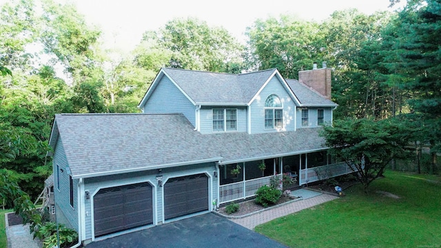 625 Lakeview Rd, Orange, CT 06477 - view of front of home with a porch, a chimney, a garage, asphalt driveway, and a front yard