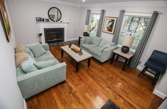 625 Lakeview Rd, Orange, CT 06477 - living room featuring crown molding, a tiled fireplace, and wood finished floors